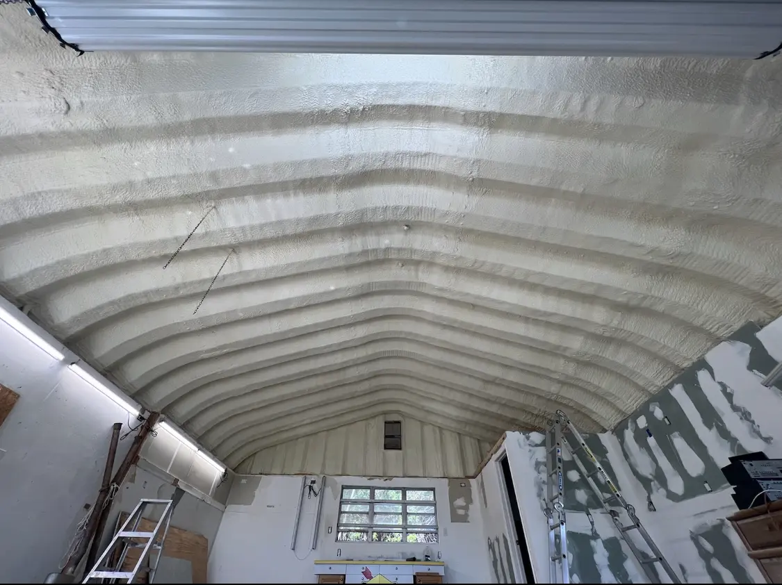 Spray polyurethane foam applied to the underside of a metal roof deck in Carlinville